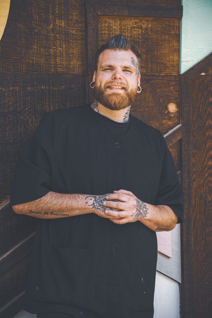 A Headshot of Josh in his Barber Gear